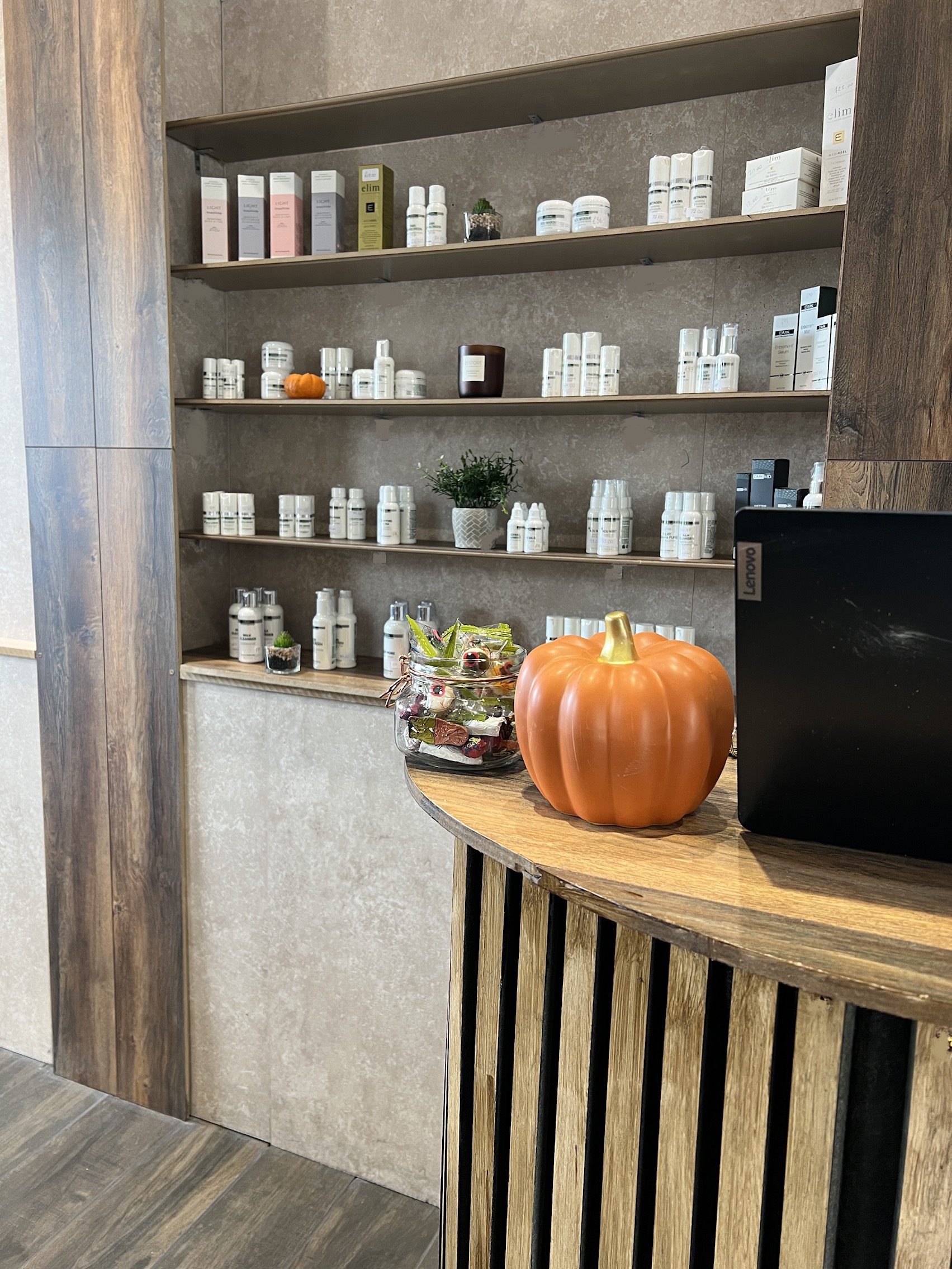 Elegant salon reception with wood accents, showcasing the professional and welcoming atmosphere at Sirens Durham.