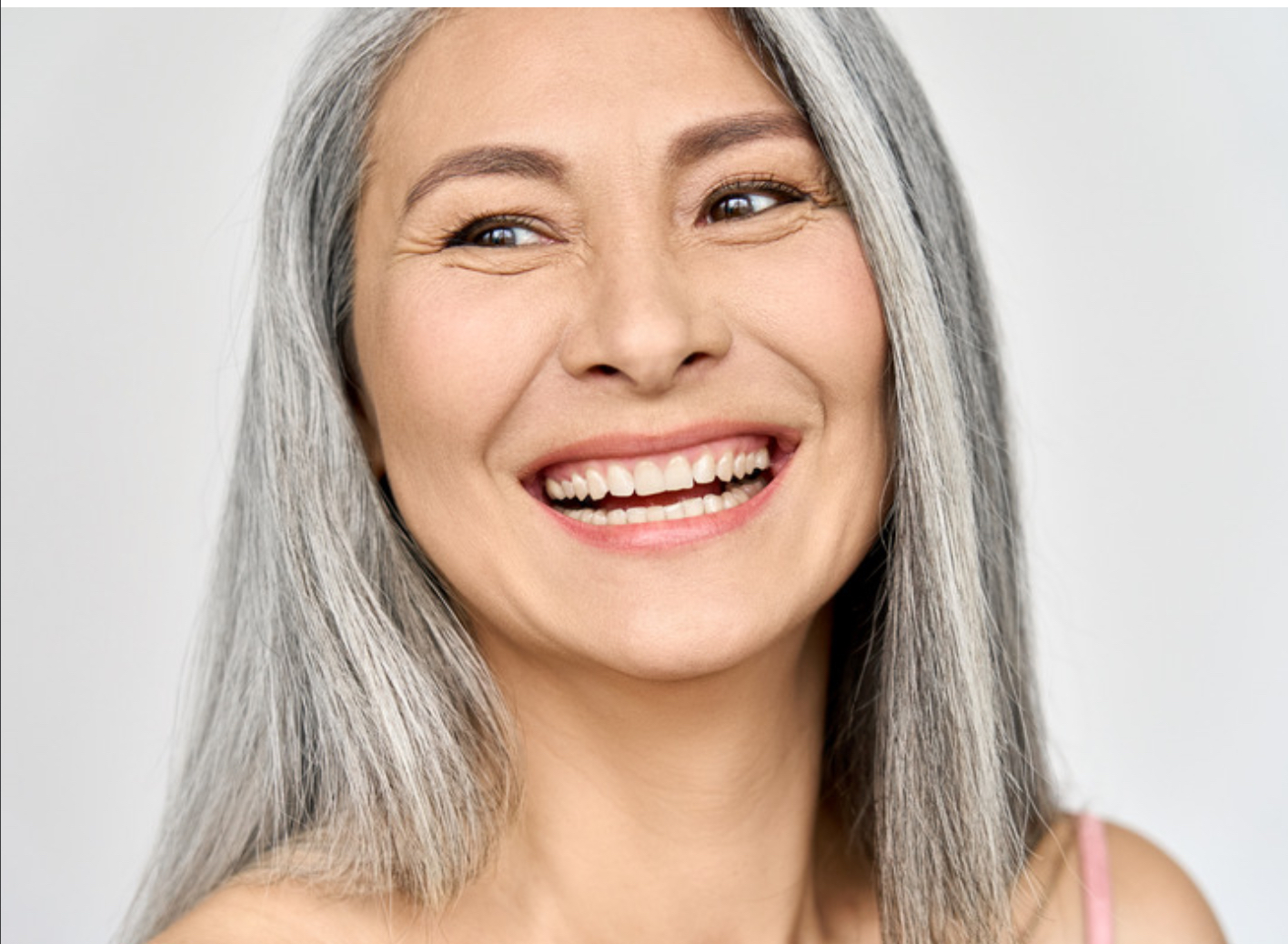 Smiling woman with healthy complexion used to illustrate skincare services for ageing skin at Sirens Hair and Beauty, Durham.