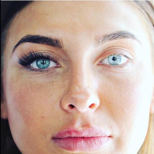 Full-face image showing one side with lash extensions applied and the other side natural, demonstrating results at Sirens Beauty Salon in Durham.